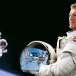 Tim Peake in a space suit. He's obviously not in space as he is holding a helmet