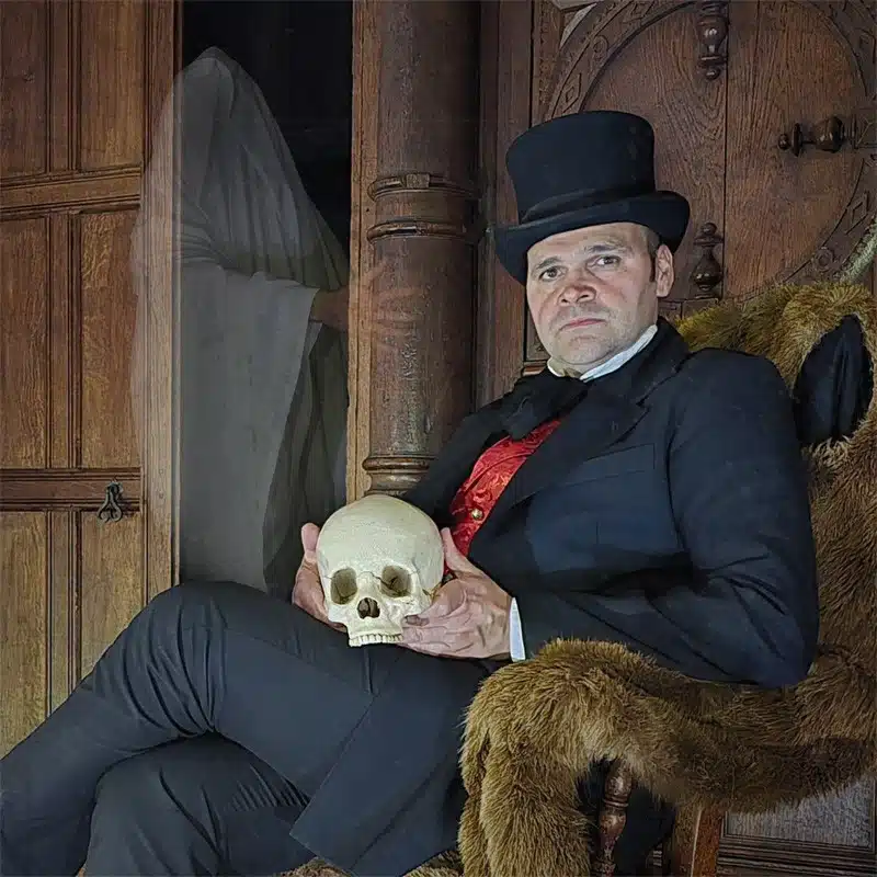 Edwyrdian Tales holding a skull to promote Ghost Stories For Christmas