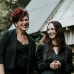 SykesMartin Two women in outdoor setting.