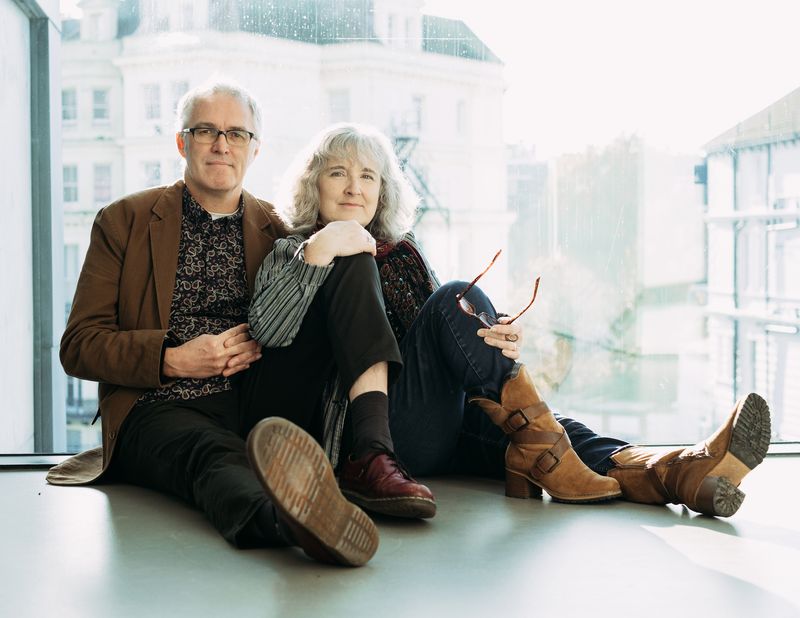 Couple sitting together indoors, relaxed.