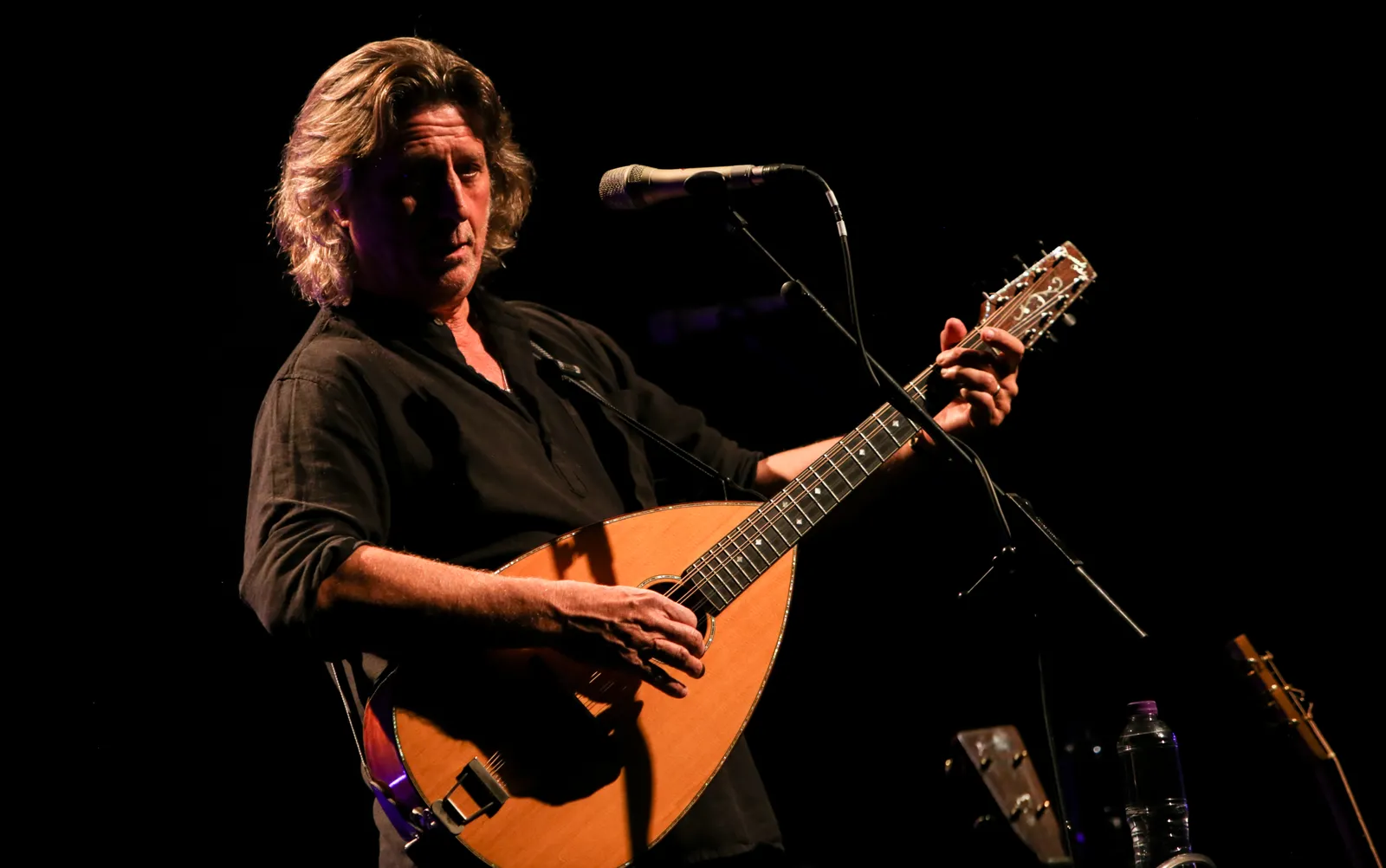 Musician performing with a string instrument.