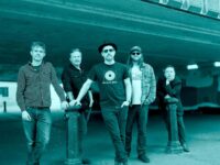 The Dreaming Spires band shot - it is a duotone image (like black and white, but tinted blue)