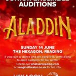 A promotional poster with a vibrant red and orange sky backdrop filled with clouds and a few sparkling stars. At the top, the words Junior Ensemble Auditions are written in bold white capital letters. Below this, the word Aladdin is displayed in large, three-dimensional golden text with a subtle metallic texture. The lower section of the poster contains white text stating Sunday 14 June, The Hexagon, Reading. Below the date and venue, a message reads If you love to dance and are aged 9-16 come along to open auditions for our panto! Check out whatsonreading.com or imaginetheatre.co.uk for full info. At the very bottom, the logos for Hexagon and Imagine Theatre are displayed side by side in white.