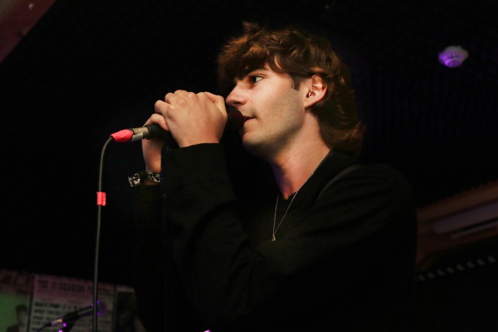 Cheap Suits singer performing into the microphone