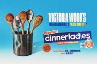 A promotional poster with a light blue background. On the left, a metal catering tin holds five wooden and metal kitchen spoons, each featuring a hand-drawn cartoon face representing a character. To the right, large stylized text reads Victoria Wood’s dinnerladies, along with subtitles stating a brand new stage adaptation, adapted for the stage by Beth and Emma Kilcoyne, and directed by Sean Foley. An orange circle notes the show is produced by the Victoria Wood Estate. A quote from The Telegraph reads, Victoria Wood’s greatest achievement is precise comic gold. A small circular insert in the bottom right features a portrait of a smiling Les Dennis, labelled starring Les Dennis as Stan.