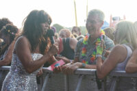Jenni Powell holding a microphone and talking to the audience