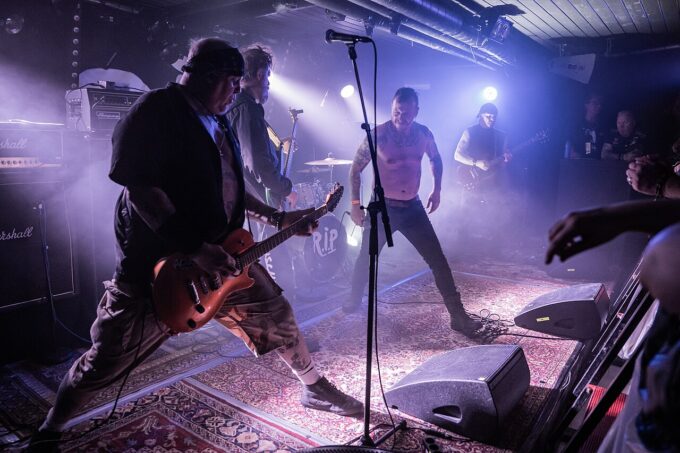 Hardcore punk band Discharge performing live on stage under concert lights