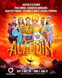 Promotional poster for the pantomime Aladdin at The Hexagon, featuring cast members Justin Fletcher, Paul Morse, Samantha Dorrance, Adam Pettigrew, JG Daniels-White, and Heléna Ferreira standing against a fiery orange background above a magical glowing lamp.