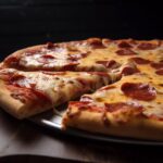 A freshly baked pepperoni pizza with melted cheese and a slice being pulled away, served on a round wooden board.